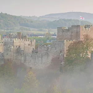 Ludlow Castle at dawn on a misty autumnal morning, Ludlow, Shropshire, England. Autumn (November) 2022