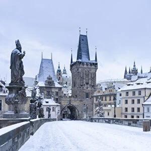 Mala Strana Bridge Tower at snow-covered Charles Bridge in winter, Prague, Bohemia