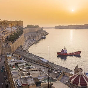 Malta, South Eastern Region, Valletta. The entrance to Grand Harbour at sunrise