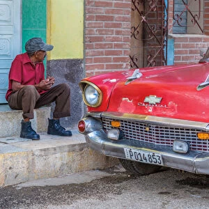 Man and classic American vintage car in Trinidad, Trinidad and Sancti Spiritus Province