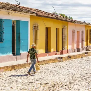A man walking in a street in Trinidad, Sancti Spiritus, Cuba A man walking in a street in Trinidad, Sancti Spiritus, Cuba
