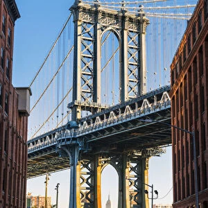 The Manhattan bridge with the Empire state building framed in the bridge, New York, USA