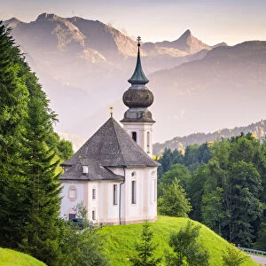 Maria Gern Church, with Bayern Alps and Mount Watzmann on the background, during sunset