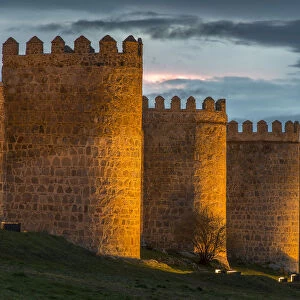 The medieval city walls illuminated at dusk, Avila, Castile and Leaon, Spain