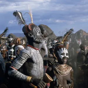 Men and women dance together in the Karo village of Duss