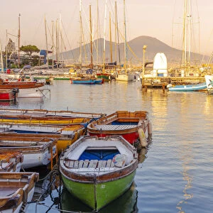 Mergellina, Naples, Campania, Italy. Fishing boat and Vesuvius Volcano on background
