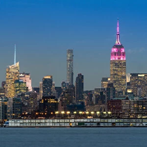Midtown skyline at dusk with the Empire State Building in pink and white colors, Manhattan
