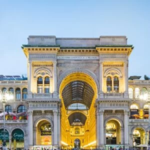 Milan, Lombardy, Italy. The entrance to the Galleria Vittorio Emanuele II illuminated