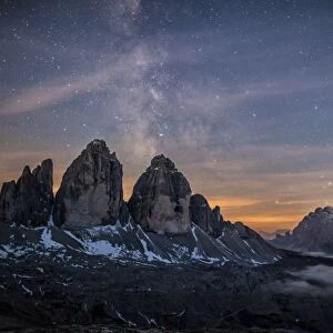 The Milky Way with its stars appear in a summer night on the Three Peaks of Lavaredo