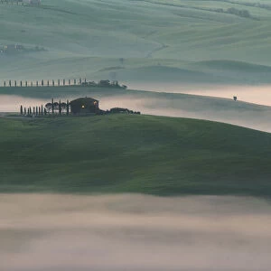 mist hanging in teh valleys of Val d Orcia, Tuscany, Italy