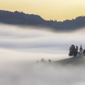 A misty dawn around St Thomas Church, Skofja Loka, Slovenia
