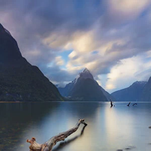 Mitre Peak reflecting in the fjord water at sunset at Milford Sound in New Zealand