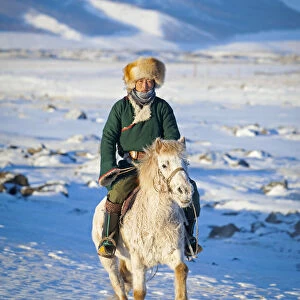 Mongolia, Ovorkhangai, Orkkhon Valley. A man approaches on horseback at sunrise