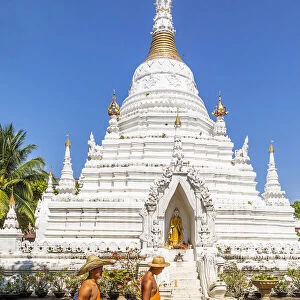 Two monks walking past a stupa in Wat Phan On temple complex, Chiang Mai