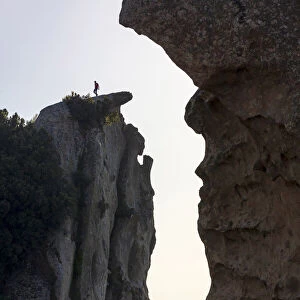 Montalbano Elicona, Messina. A man walking on the edge of the rock formations in the