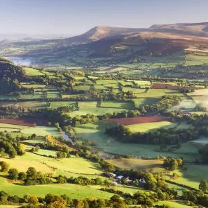 Morning sunshines illuminates the patchwork fields in the Usk Valley, looking towards