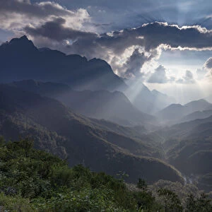 Mountain scenery near Sapa with rays of sun behind the clouds, Sapa, Vietnam