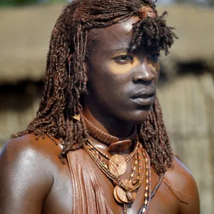 A Msai warrior with his long braids and body coated