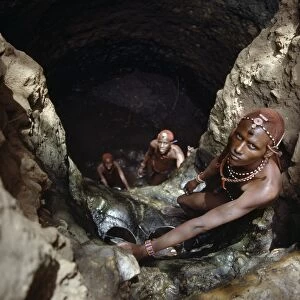 Msai warriors draw water from a deep well