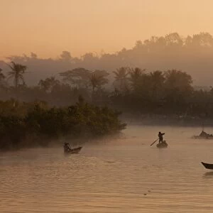 Myanmar, Burma, Mrauk U. Early morning mist rising on the Aungdat Creek