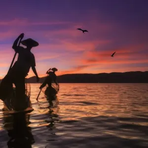 Myanmar (Burma), Shan State, Inle Lake, local fishermen at sunset Myanmar (Burma), Shan State, Inle Lake, local fishermen at sunset