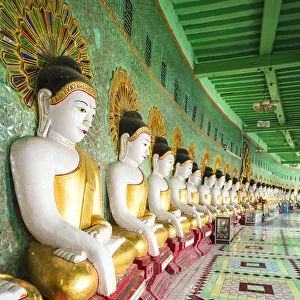 Myanmar, Mandalay. Sagaing Hil, Buddha statues inside Umin Thounzeh temple