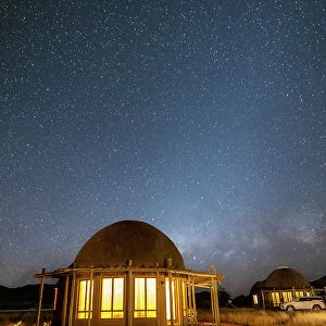 Namibia, illuminated rooms under the milky way in a game reserve safari lodge in Namib Naukluft National Park