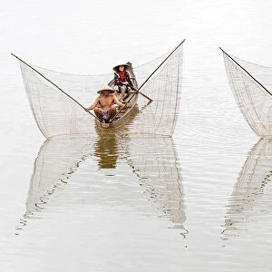 Net casting fishermen on the Perfume River, Hue, Vietnam