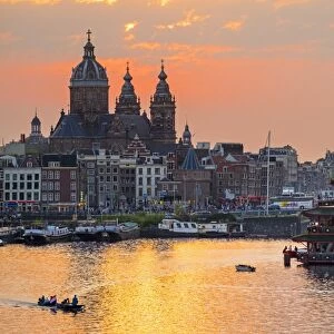 Netherlands, North Holland, Amsterdam. City skyline at sunset with domes of Basilica