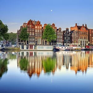 Netherlands, North Holland, Amsterdam. Typical houses and houseboats on Amstel river