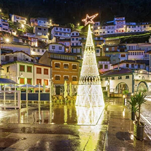 Night view of the main square adorned with Christmas tree, Cudillero, Asturias, Spain