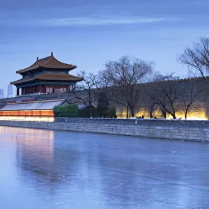 North Gate and moat of Forbidden City at dusk with CITIC Tower in background, Beijing