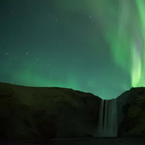 Northern lights over Skogafoss waterfall, Southern Iceland, Iceland