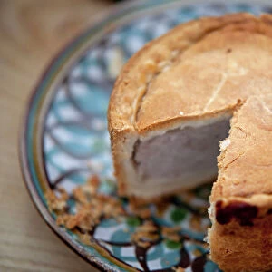 Nottinghamshire, UK. Melton Mowbray pork pie on handmade ceramic plate