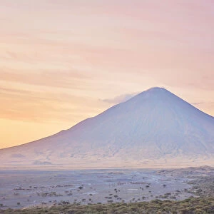 The "Ol Doinyo Lengai"volcano at sunrise, Arusha Region, Tanzania. An active volcano in the Gregory Rift, south of Lake Natron, considered by the Msai people as "The Mountain of God"