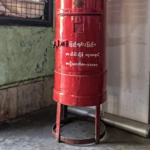 Old colonial style red letterbox in post office in Yangon, Myanmar