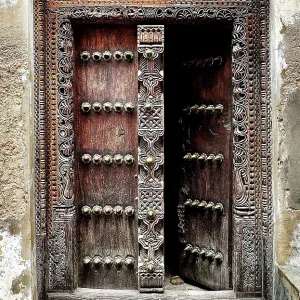 Old heavy carved wooden door, Stonetown, Zanzibar, Tanzania Old heavy carved wooden door, Stonetown, Zanzibar, Tanzania