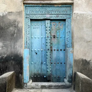 Old heavy carved wooden door, Stonetown, Zanzibar, Tanzania Old heavy carved wooden door, Stonetown, Zanzibar, Tanzania
