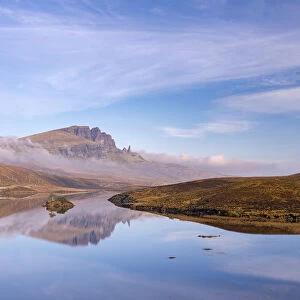 The Old Man of Storr reflected in a mirror still Loch Fada, Isle of Skye, Scotland, UK