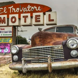 Old rusted Pontiac car and vintage motel sign behind along the historic U. S. Route 66 Old rusted Pontiac car and vintage motel sign behind along the historic U. S. Route 66