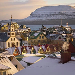 The old part of Torshavn covered by snow. In the background the island of Nolsoy. Streymoy, Faroe Islands