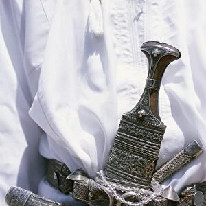Omani men wear the traditional long white robes and