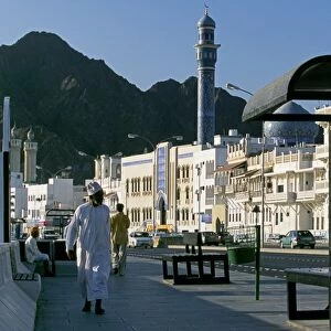 Omanis walk and sit alongside Muttrahs busy Corniche