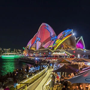 Opera Bar and Sydney Opera House illuminated with projections during Vivid Sydney