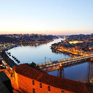 Oporto, capital of the Port wine, with the Douro river and Dom Luis bridge at sunset