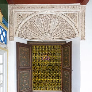 Ornate window, Courtyard gardens at Bahia Palace (Palais de la Bahia). Marrakech-Safi (Marrakesh-Tensift-El Haouz) region, Marrakesh, Morocco