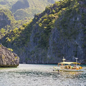 Outrigger boat anchored at Twin Peaks Reef off the coast of Coron Island, Coron, Palawan