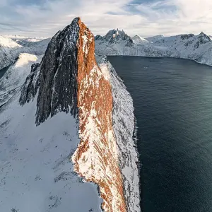 Overhead view of steep ridge of Segla mountain covered with snow at sunset, aerial view, Senja, Troms county, Norway Overhead view of steep ridge of Segla mountain covered with snow at sunset, aerial view, Senja, Troms county, Norway