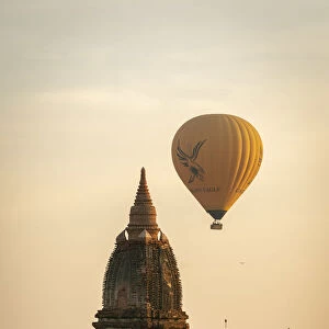 Pagoda and hot air balloon at sunrise, Bagan, Myanmar