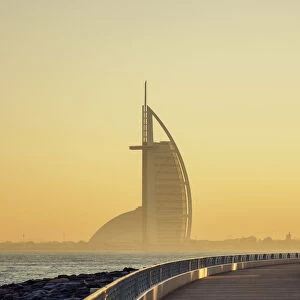 Palm Jumeirah Boardwalk and Burj Al Arab Hotel at sunrise, Dubai, United Arab Emirates